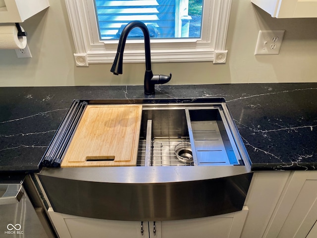 room details featuring sink and white cabinets