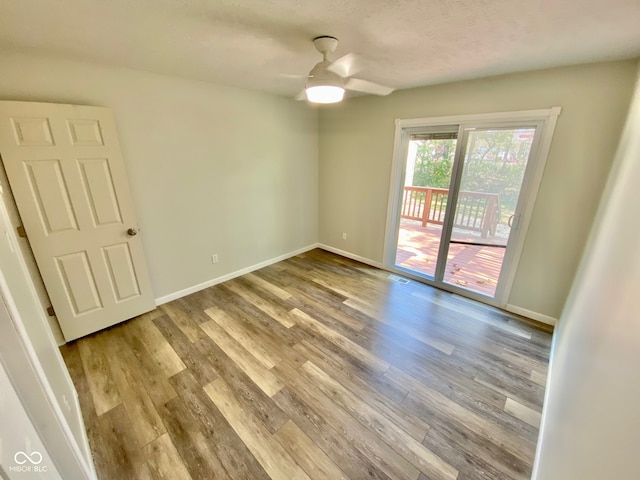 unfurnished room with ceiling fan, light hardwood / wood-style floors, and a textured ceiling