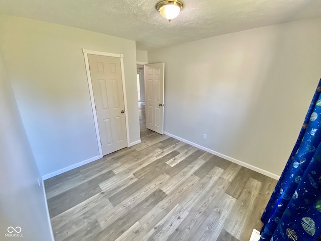 empty room featuring hardwood / wood-style floors and a textured ceiling