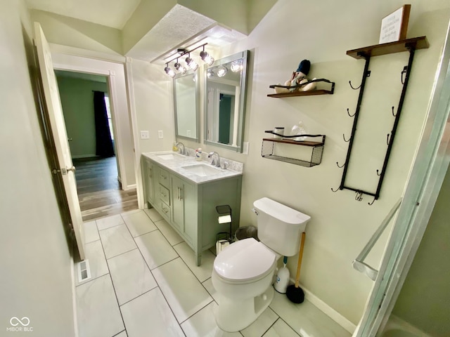 bathroom with hardwood / wood-style floors, vanity, and toilet