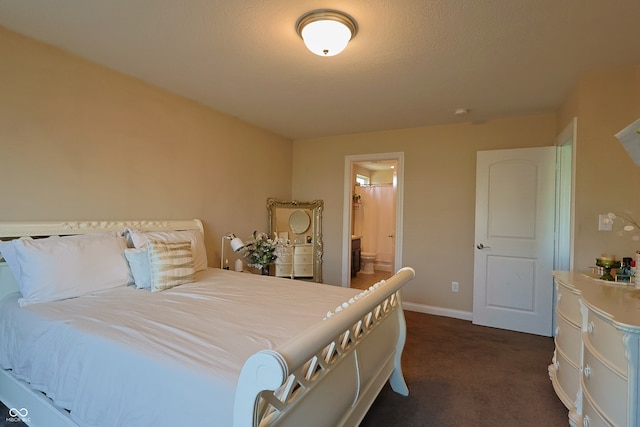 carpeted bedroom featuring a textured ceiling and ensuite bath