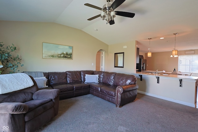 carpeted living room featuring vaulted ceiling and ceiling fan