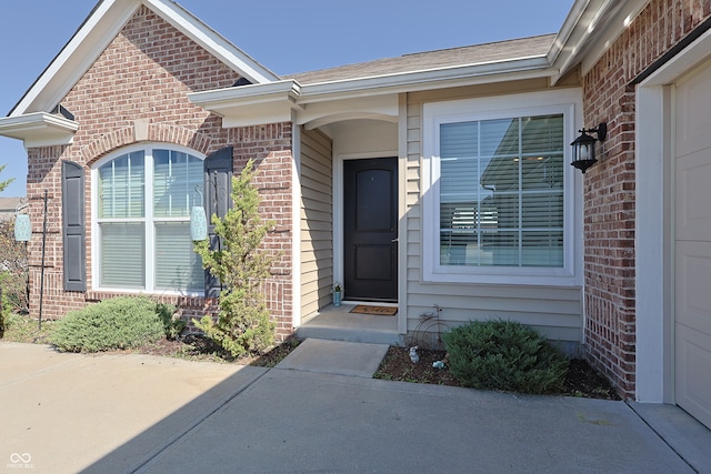 doorway to property with a garage