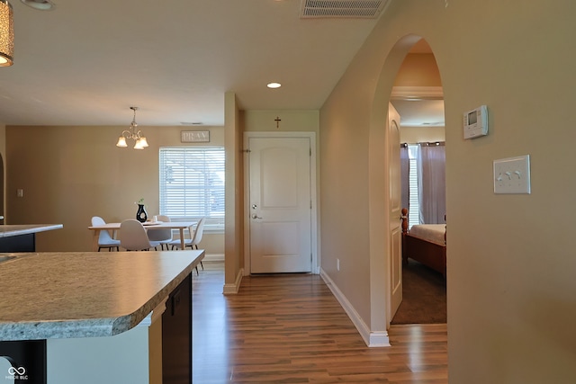 kitchen with decorative light fixtures, dark hardwood / wood-style floors, and a chandelier