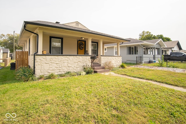 view of front of house with a porch and a front yard