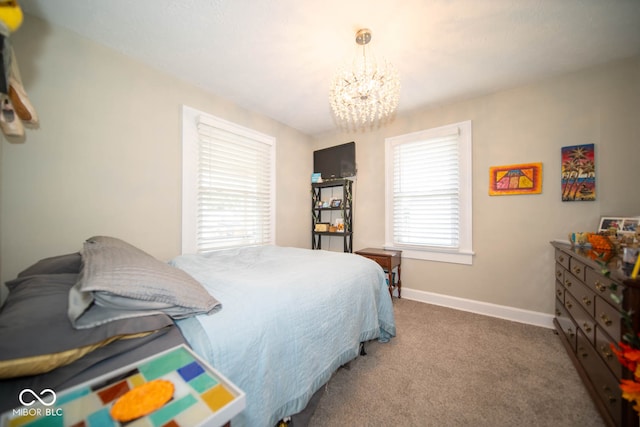 carpeted bedroom with an inviting chandelier