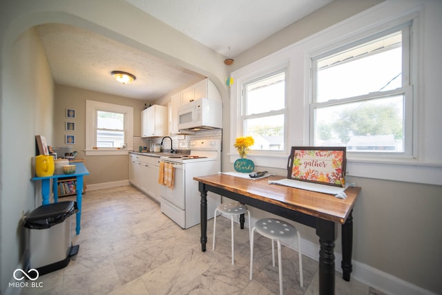 kitchen with white cabinets, sink, tasteful backsplash, white appliances, and a textured ceiling