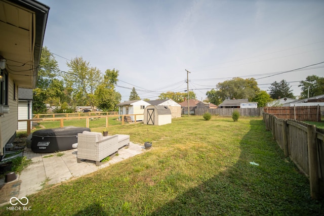 view of yard featuring a storage shed and a patio area