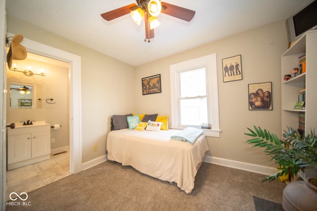 bedroom featuring ceiling fan, ensuite bath, and light carpet