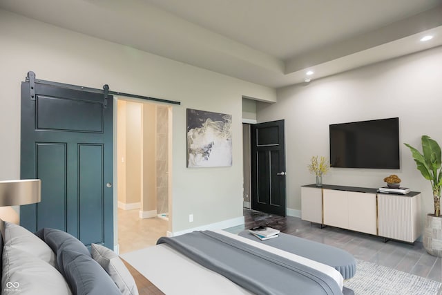 bedroom with ensuite bathroom and a barn door