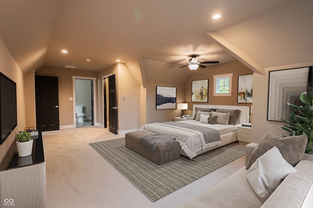 carpeted bedroom featuring lofted ceiling, ensuite bath, and ceiling fan