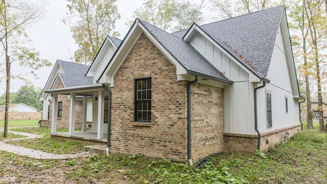 view of side of property featuring covered porch