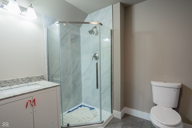 bathroom featuring toilet, tile patterned flooring, an enclosed shower, and vanity