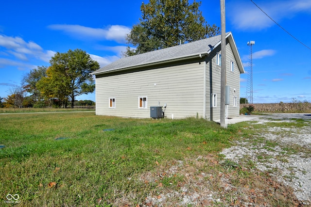 view of home's exterior with a yard and cooling unit