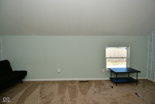 sitting room with light carpet and lofted ceiling