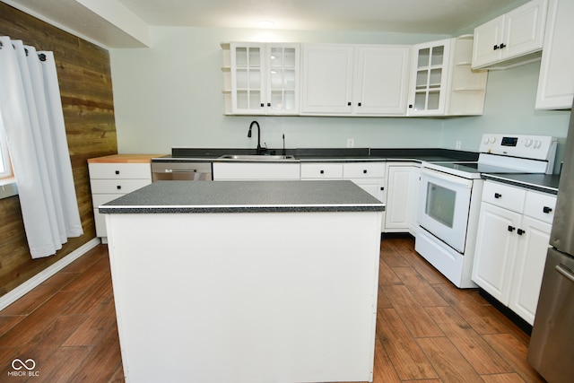 kitchen with dark hardwood / wood-style flooring, white cabinets, a center island, and white appliances