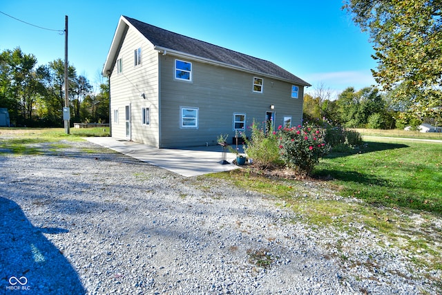 exterior space with a patio area and a yard