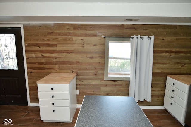 unfurnished bedroom with wood walls