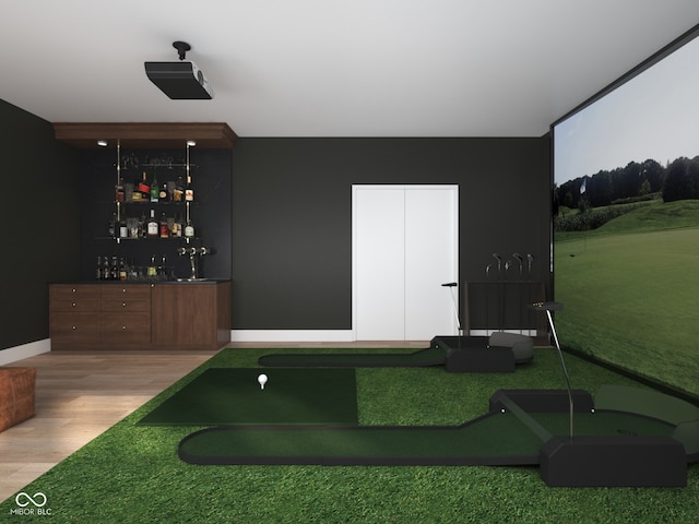 1717 Beaufain St, Carmel, IN 46032 - exercise area featuring wood finished floors, a dry bar, baseboards, and an area to practice putting