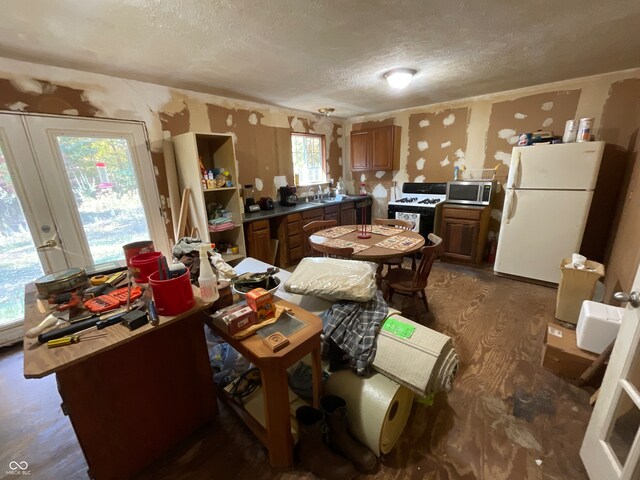 miscellaneous room featuring french doors, a textured ceiling, sink, and dark hardwood / wood-style flooring