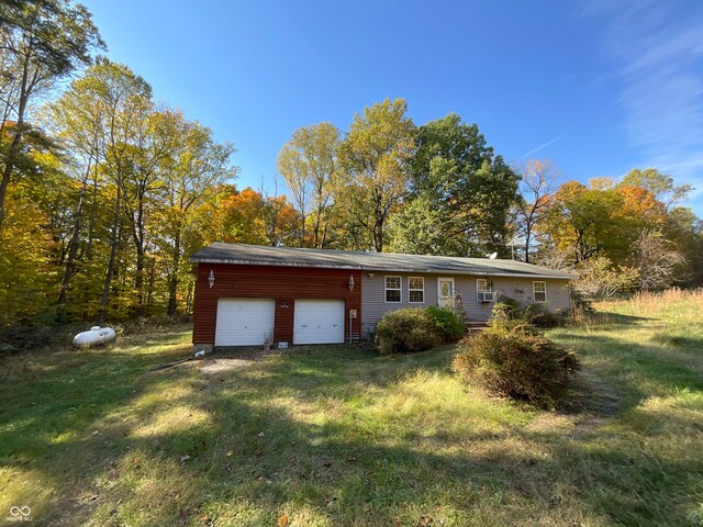 exterior space with a garage and a front lawn