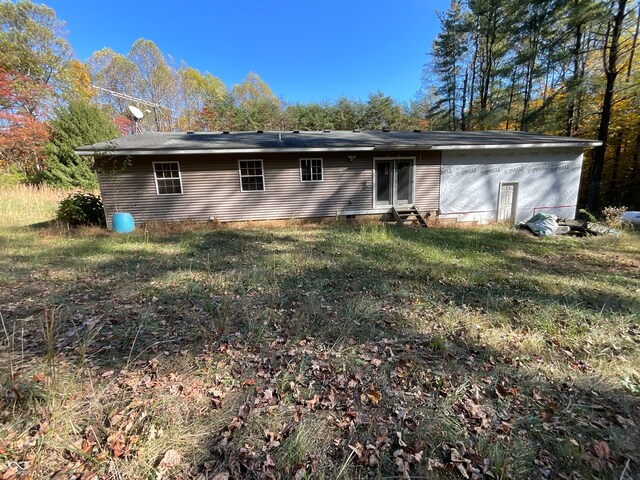 back of house with a lawn