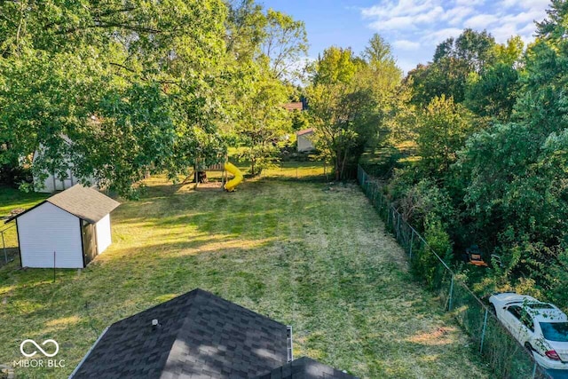 view of yard featuring a storage shed and a playground