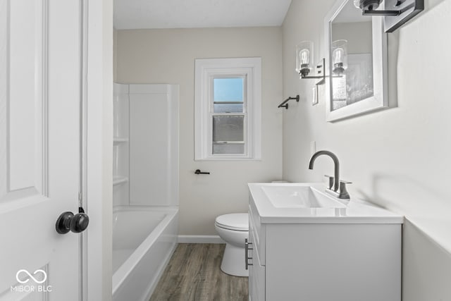 full bathroom featuring toilet, vanity, wood-type flooring, and tub / shower combination