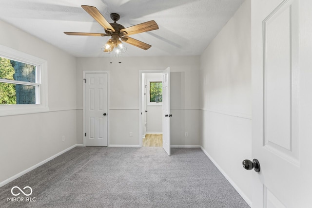 unfurnished room with carpet floors, a textured ceiling, and ceiling fan