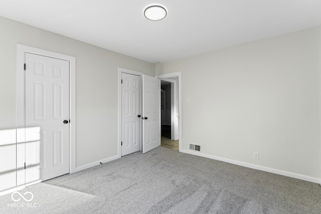 unfurnished bedroom featuring light carpet