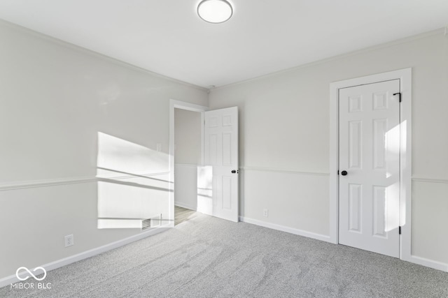 carpeted spare room with crown molding