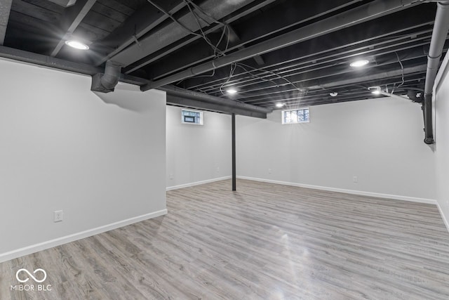 basement featuring hardwood / wood-style floors