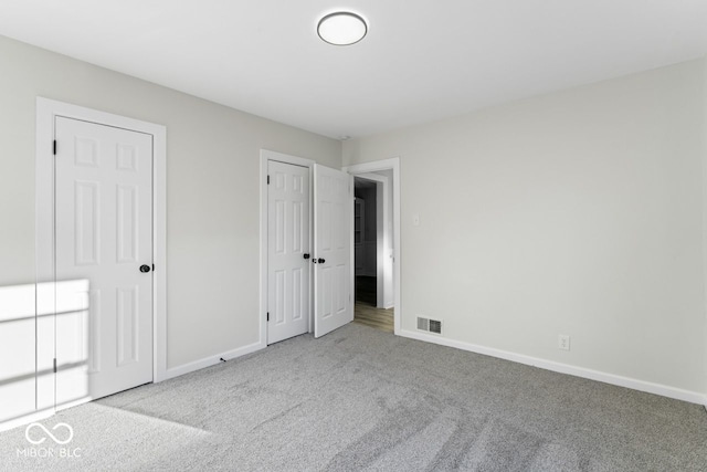 unfurnished bedroom featuring light colored carpet