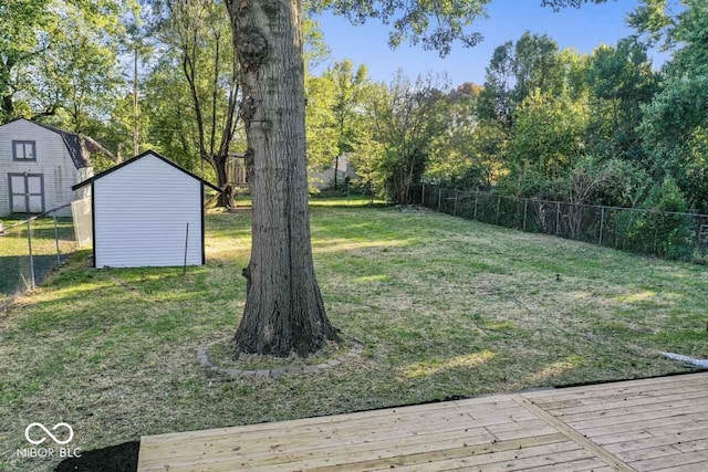 view of yard with a shed and a deck