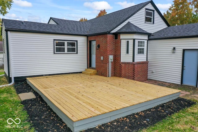 rear view of house featuring a wooden deck