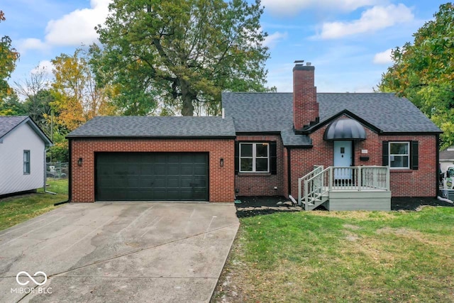 view of front of home with a front yard and a garage