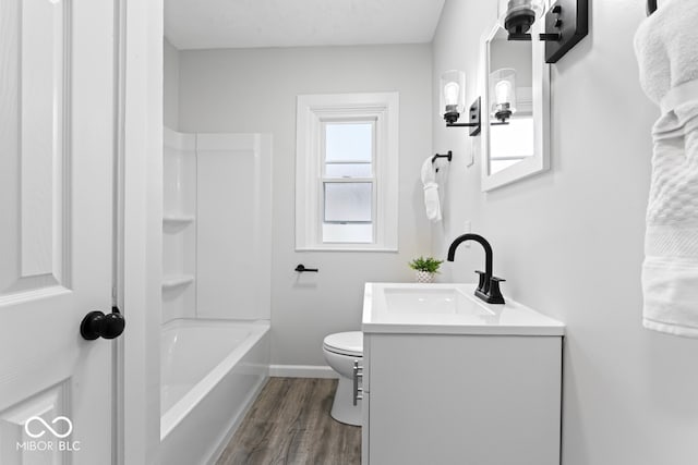 full bathroom featuring vanity, toilet, wood-type flooring, and shower / bathtub combination