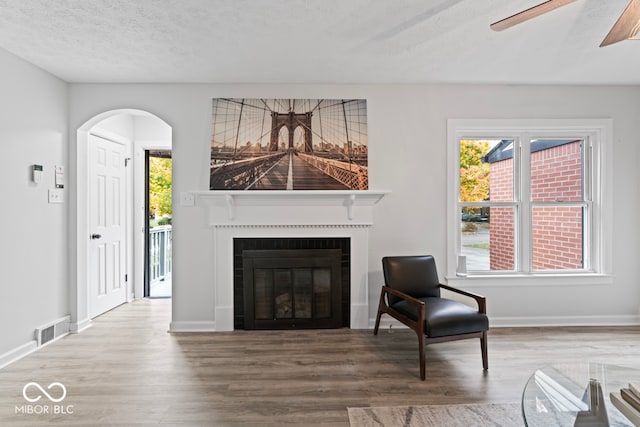 living room with hardwood / wood-style flooring and a textured ceiling