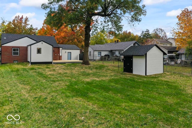 back of property featuring a storage shed and a lawn