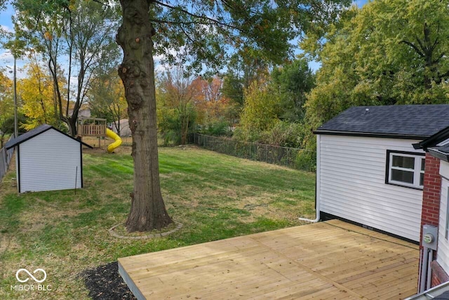 view of yard with a storage shed and a deck