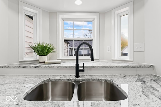 room details with sink and light stone countertops