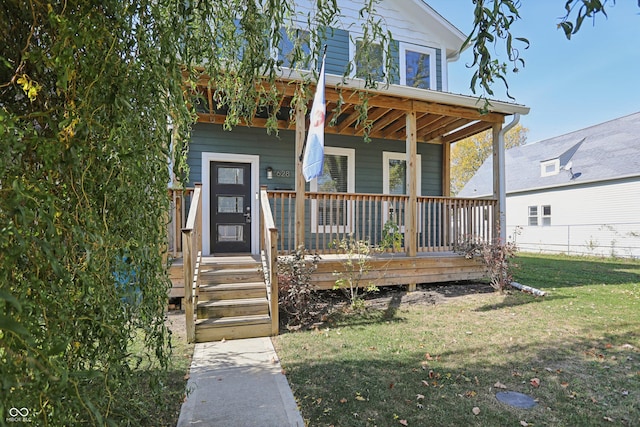 view of front of house featuring covered porch and a front yard