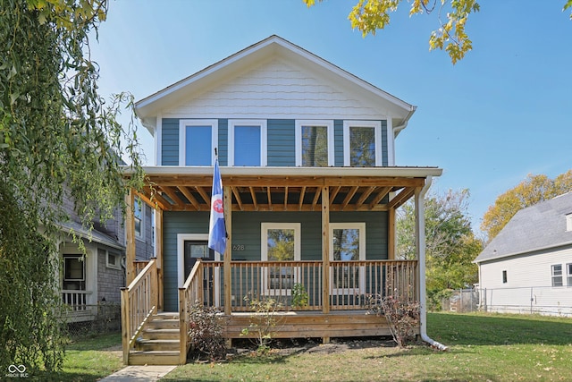 view of front of property featuring covered porch and a front lawn