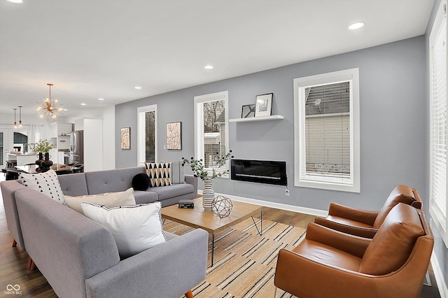 living room featuring an inviting chandelier and hardwood / wood-style floors