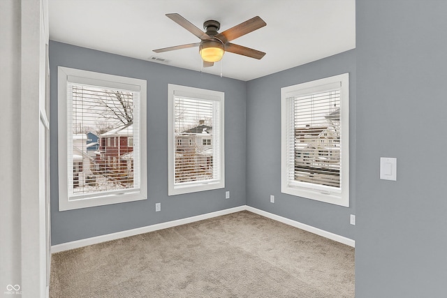 carpeted empty room featuring ceiling fan