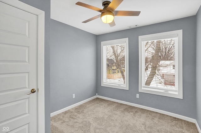 carpeted empty room featuring ceiling fan