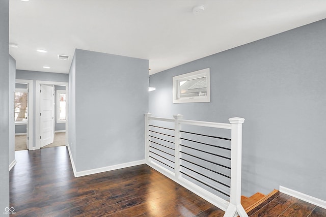 hallway with dark hardwood / wood-style floors