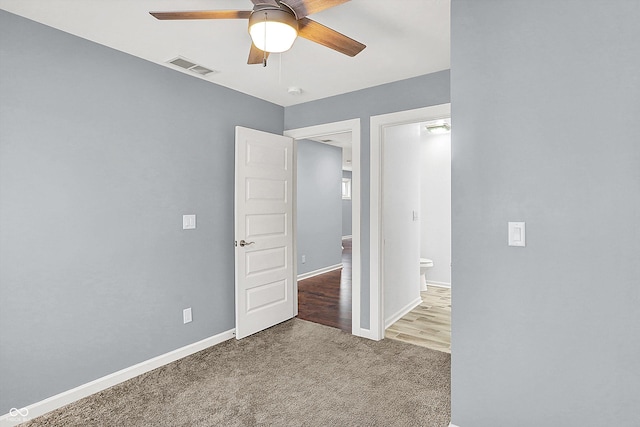 carpeted spare room with ceiling fan