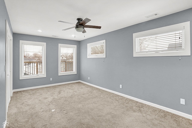 empty room featuring light carpet and ceiling fan