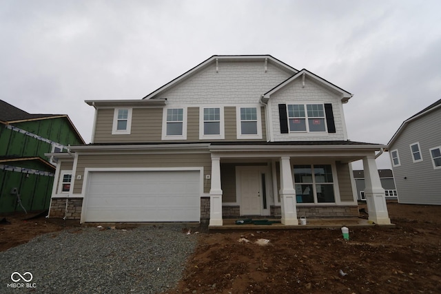 craftsman-style home with covered porch and a garage